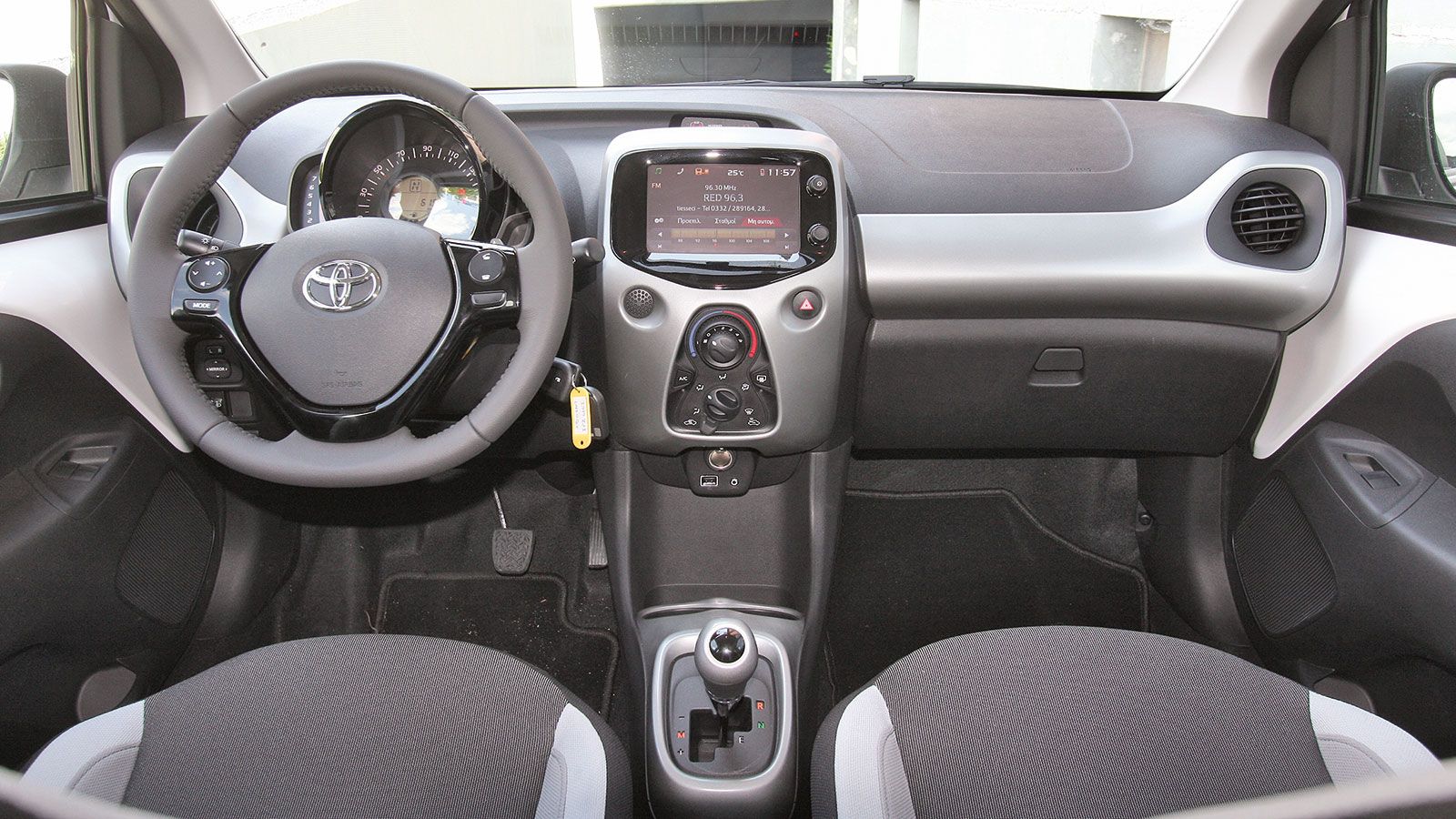 Στο εσωτερικό του Aygo τα σκληρά πλαστικά έχουν σωστή συναρμογή, ενώ λεπτομέρειες όπως το στροφόμετρο και η μεγάλη οθόνη αφής κάνουν νεανική την εικόν