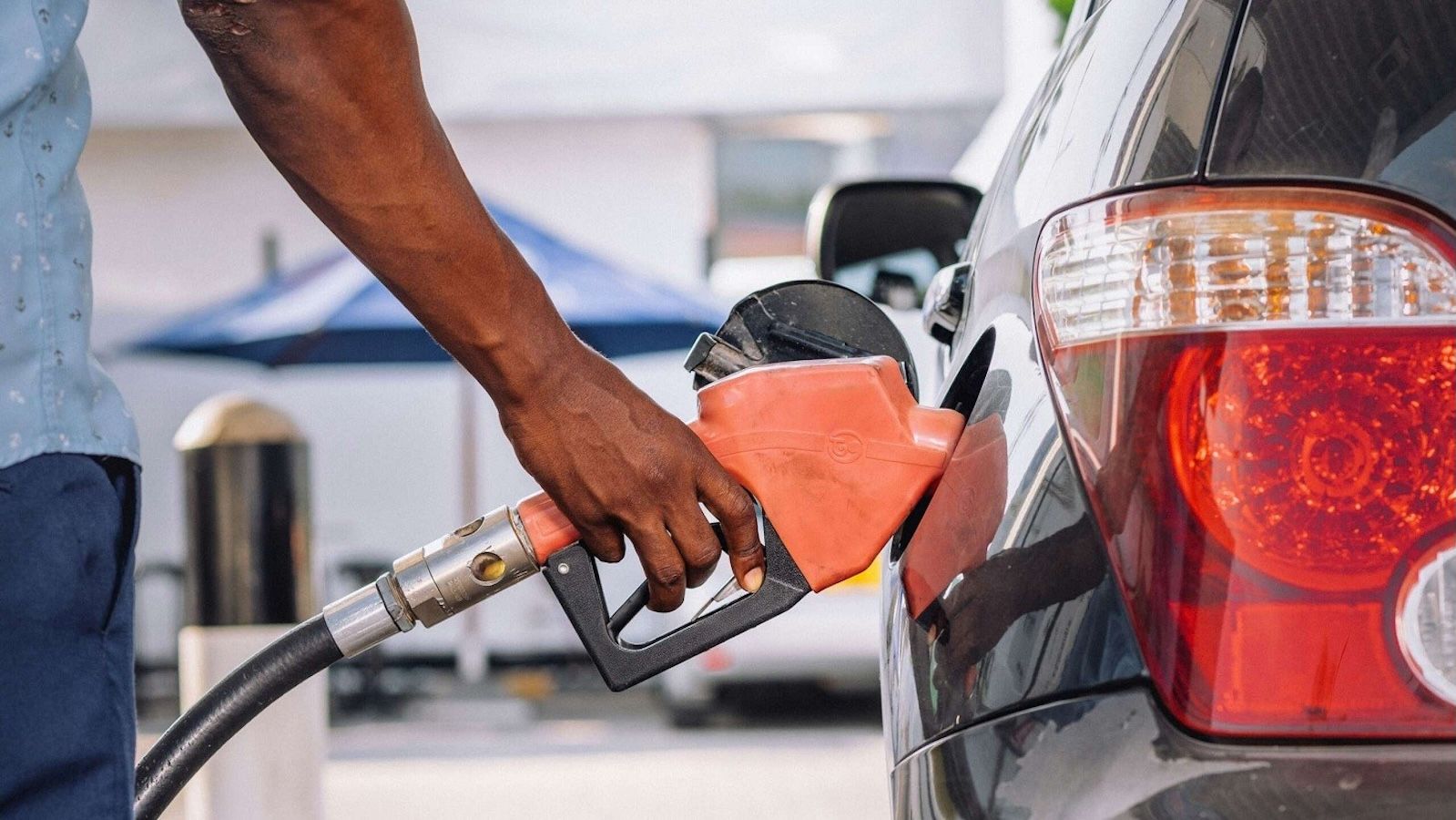 man puts gas on a car